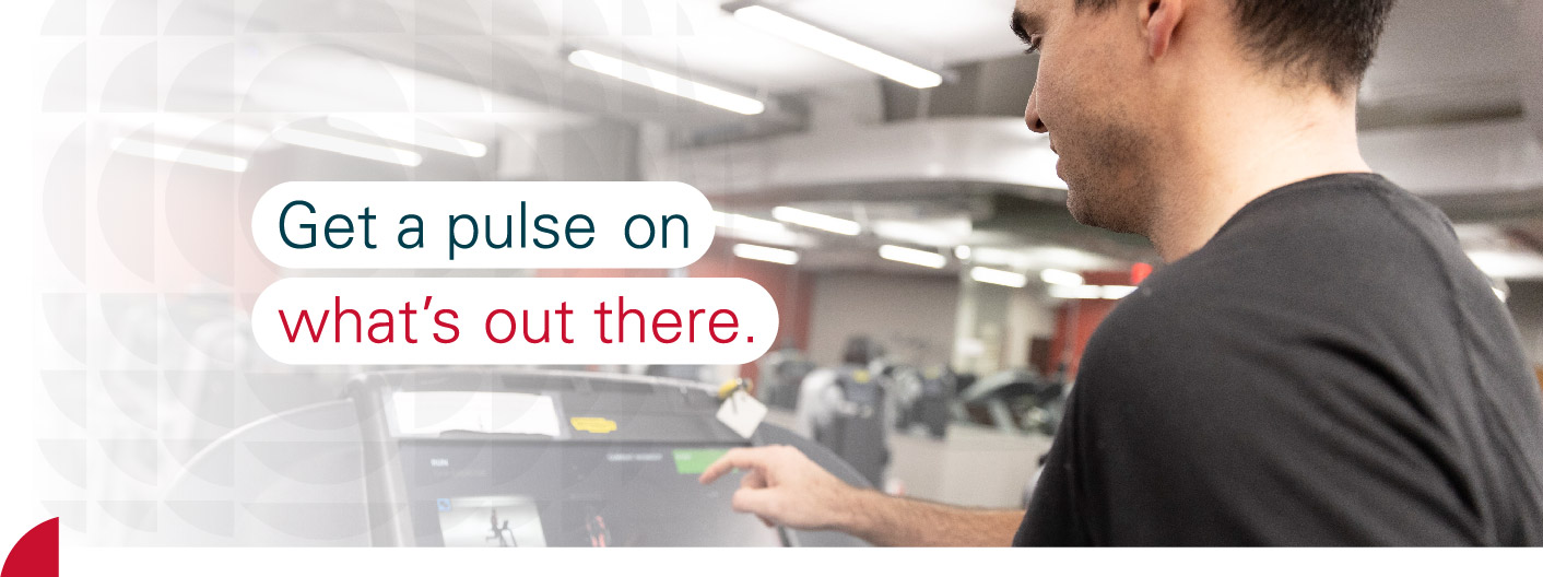 Adult student looking at a display on a treadmill in a gym with text reading get a pulse on what's out there