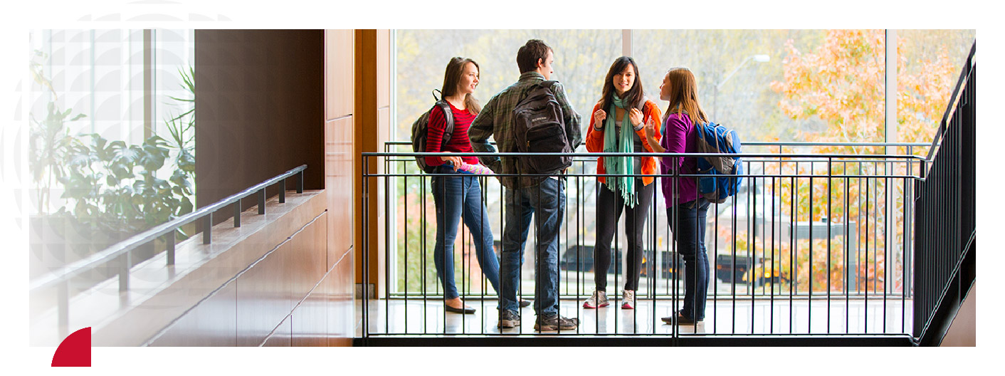 Group of students having conversation in an atrium setting