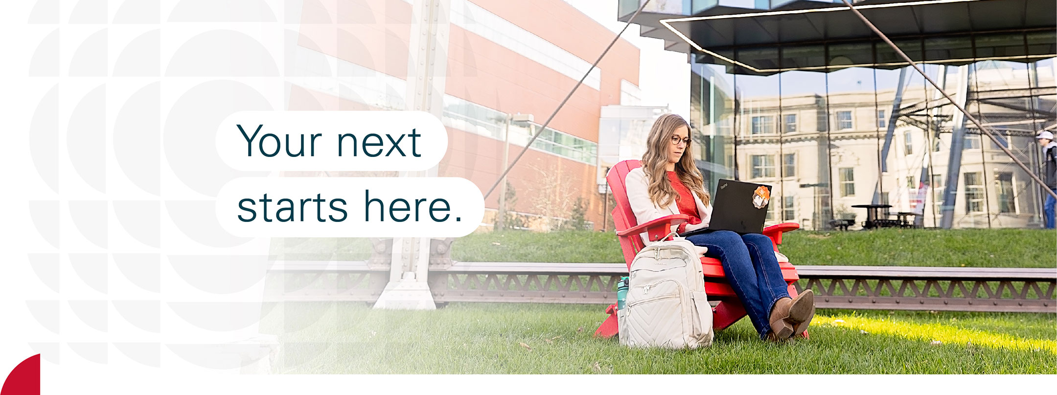 Student sitting in a chair with the text your next starts here.